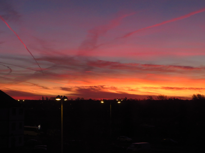 A photo of a sunset over a town