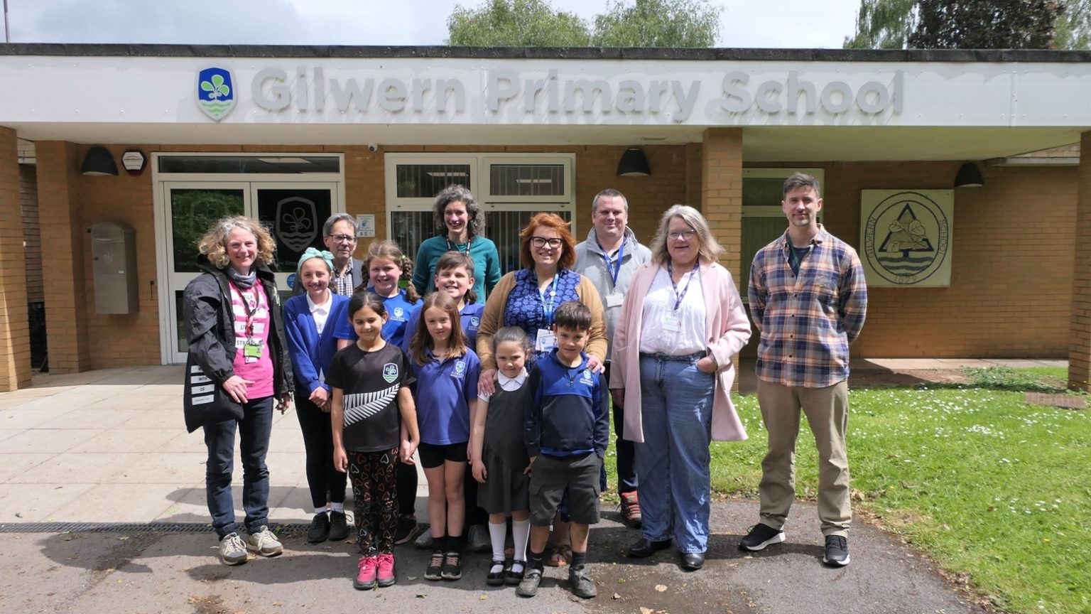 an image of pupils and adults standing in front of Gilwern primary School