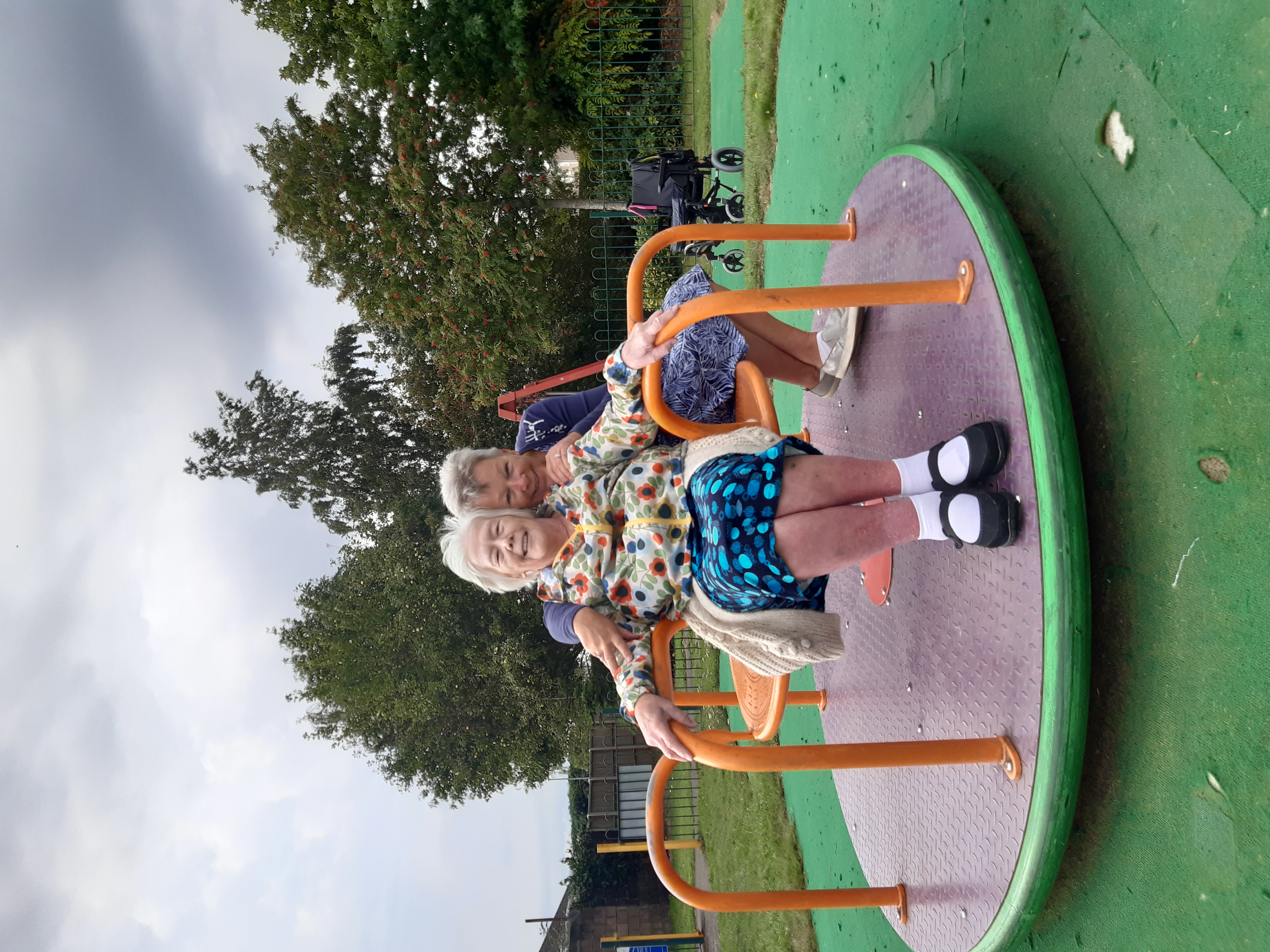 Two older people on a playground set