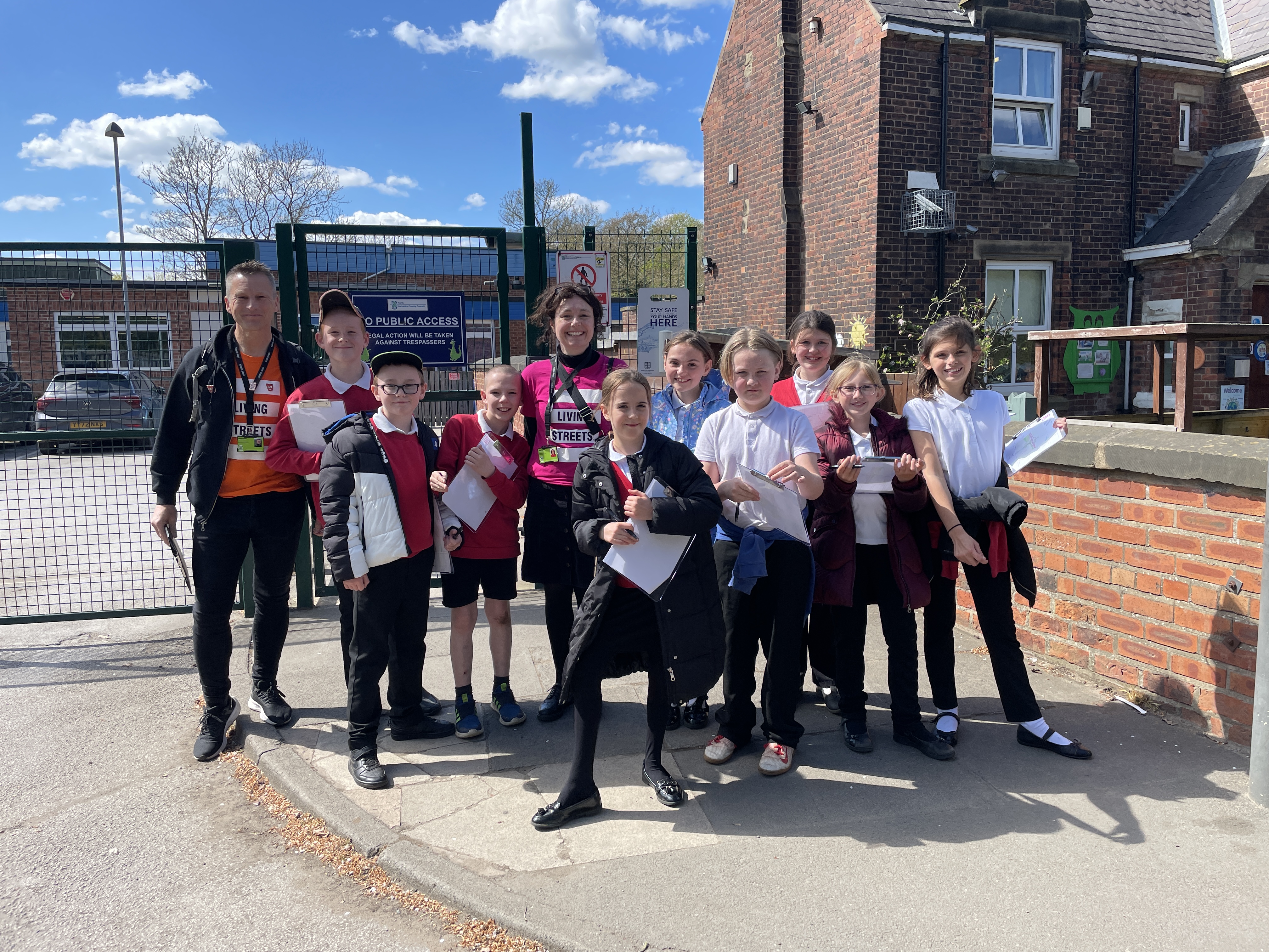 A group of children are on a local street with Living Streets staff carrying out a School Route Audit