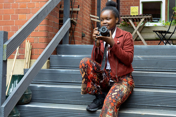 A young girl taking a photo