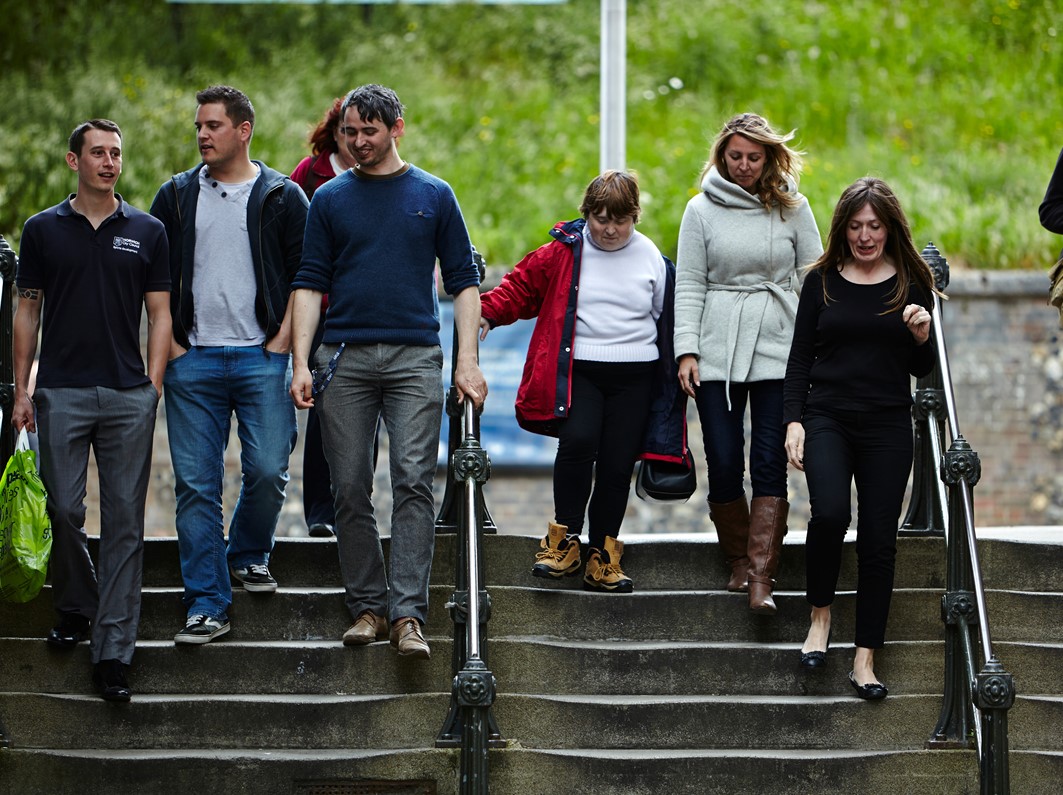 A group of young people walking down a set of stairs