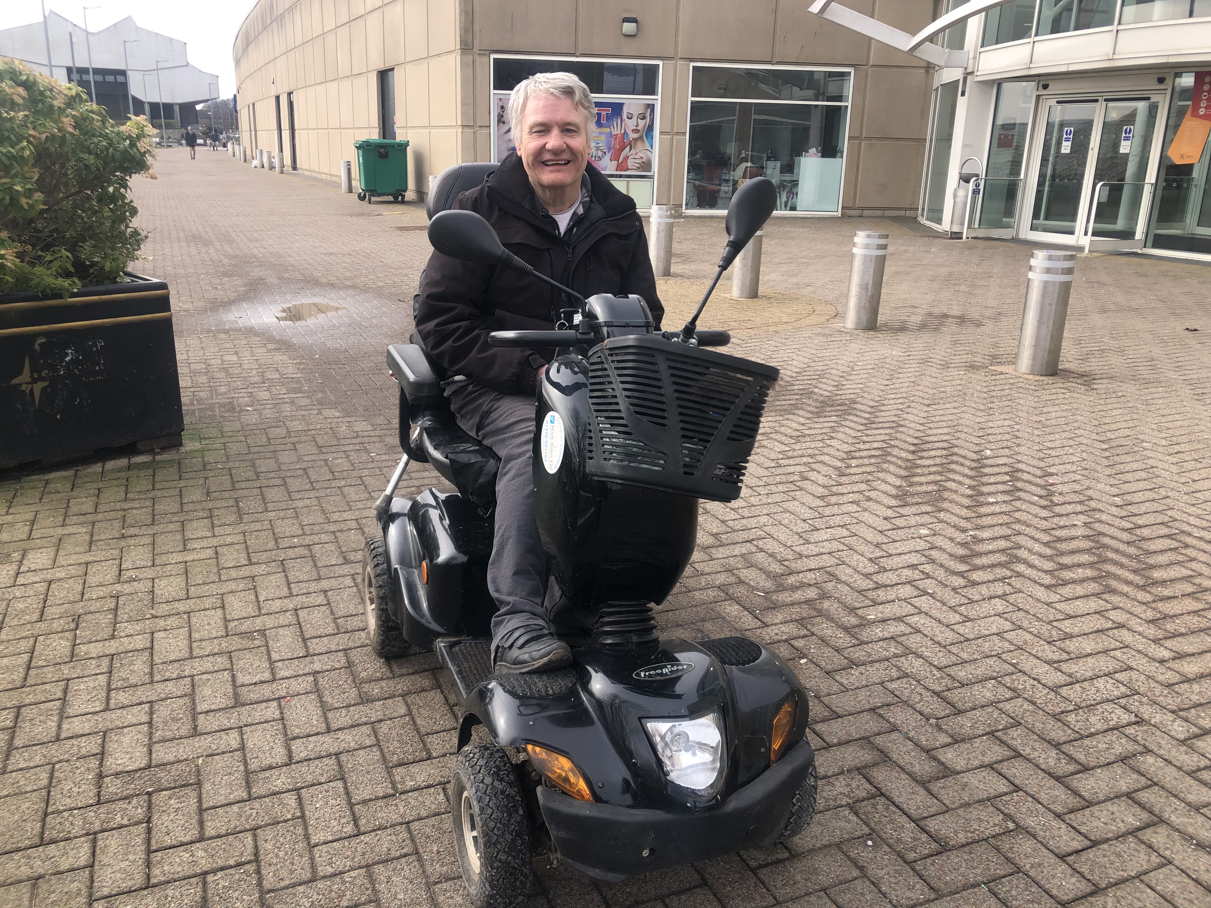 an elderly man on a mobility scooter