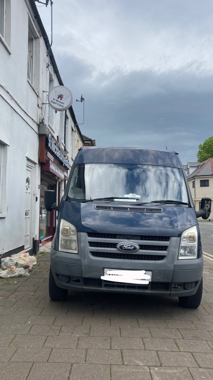 A van parked across a pavement