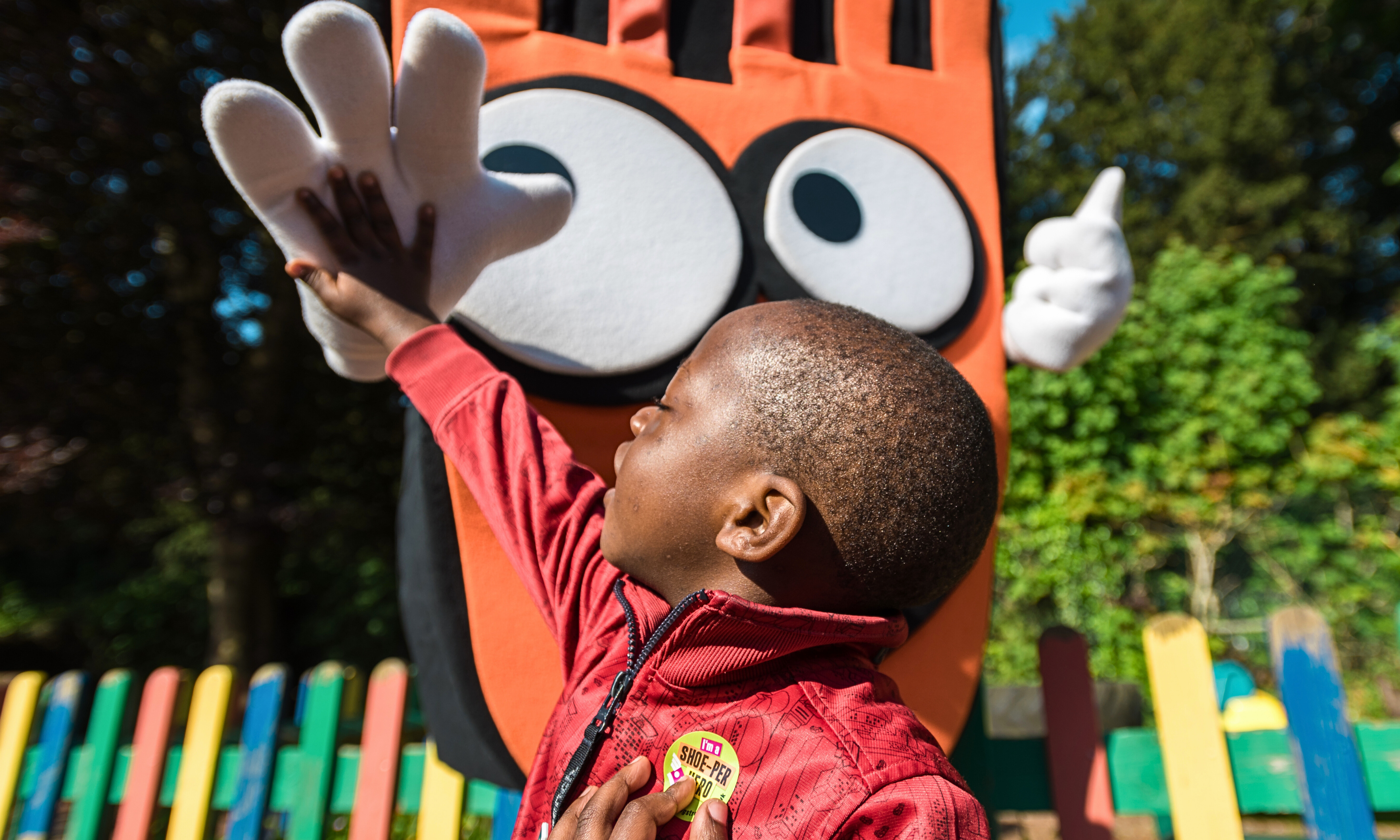 black male child gives Strider a high five