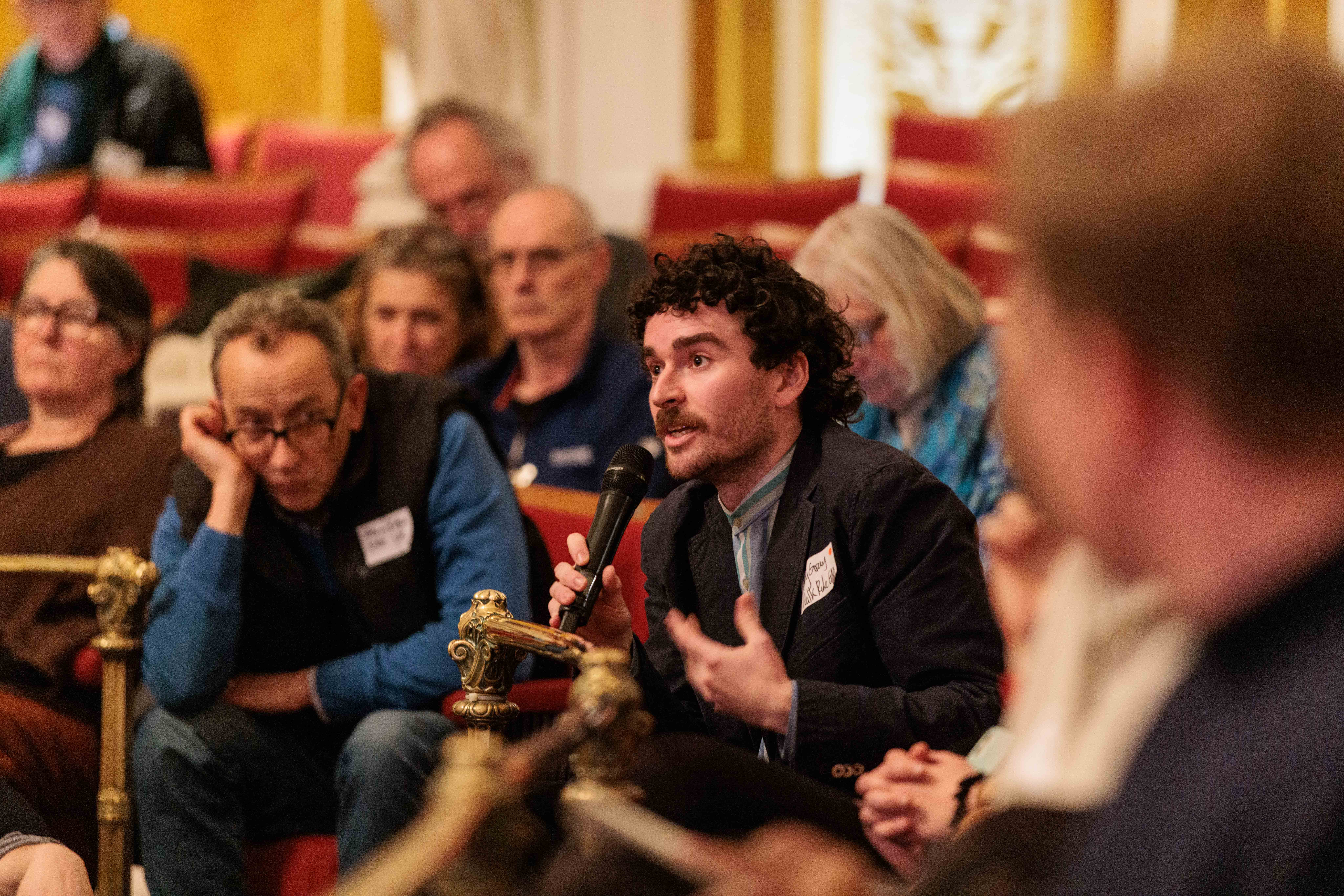 Audience member asking a question at the summit