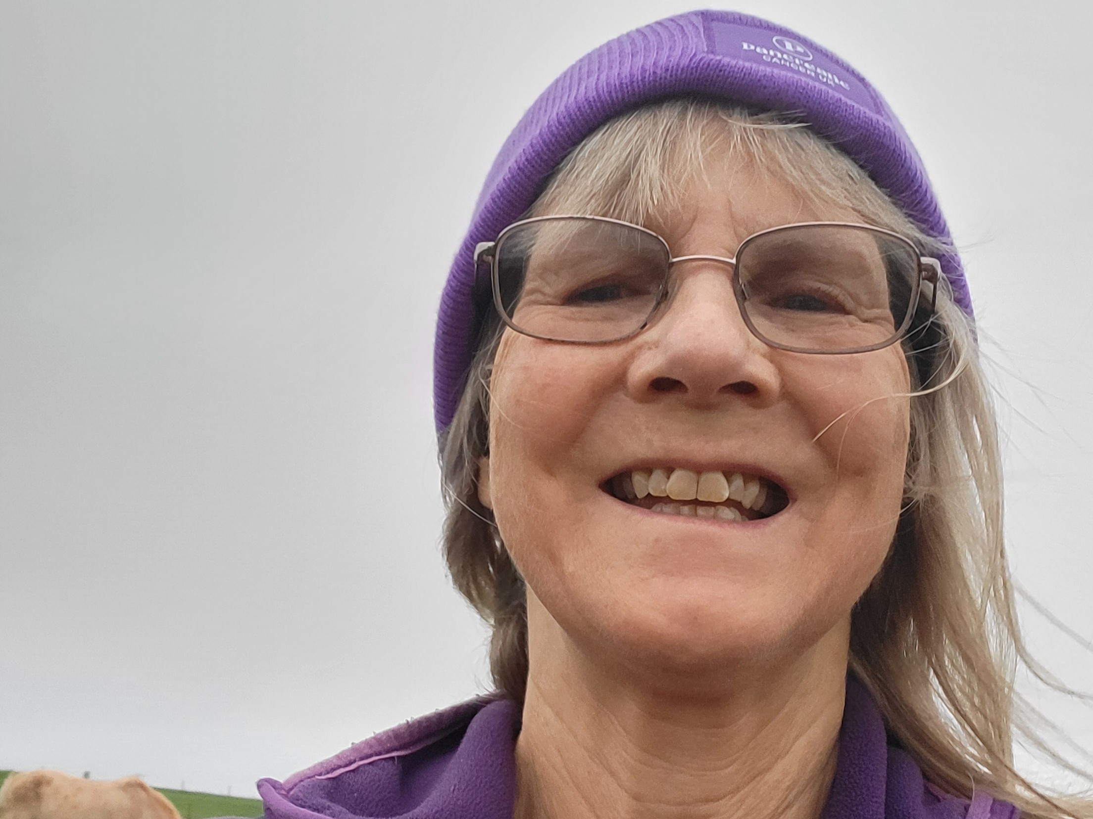 Alicia Coumbe, an older white woman. Alicia is smiling at the camera.