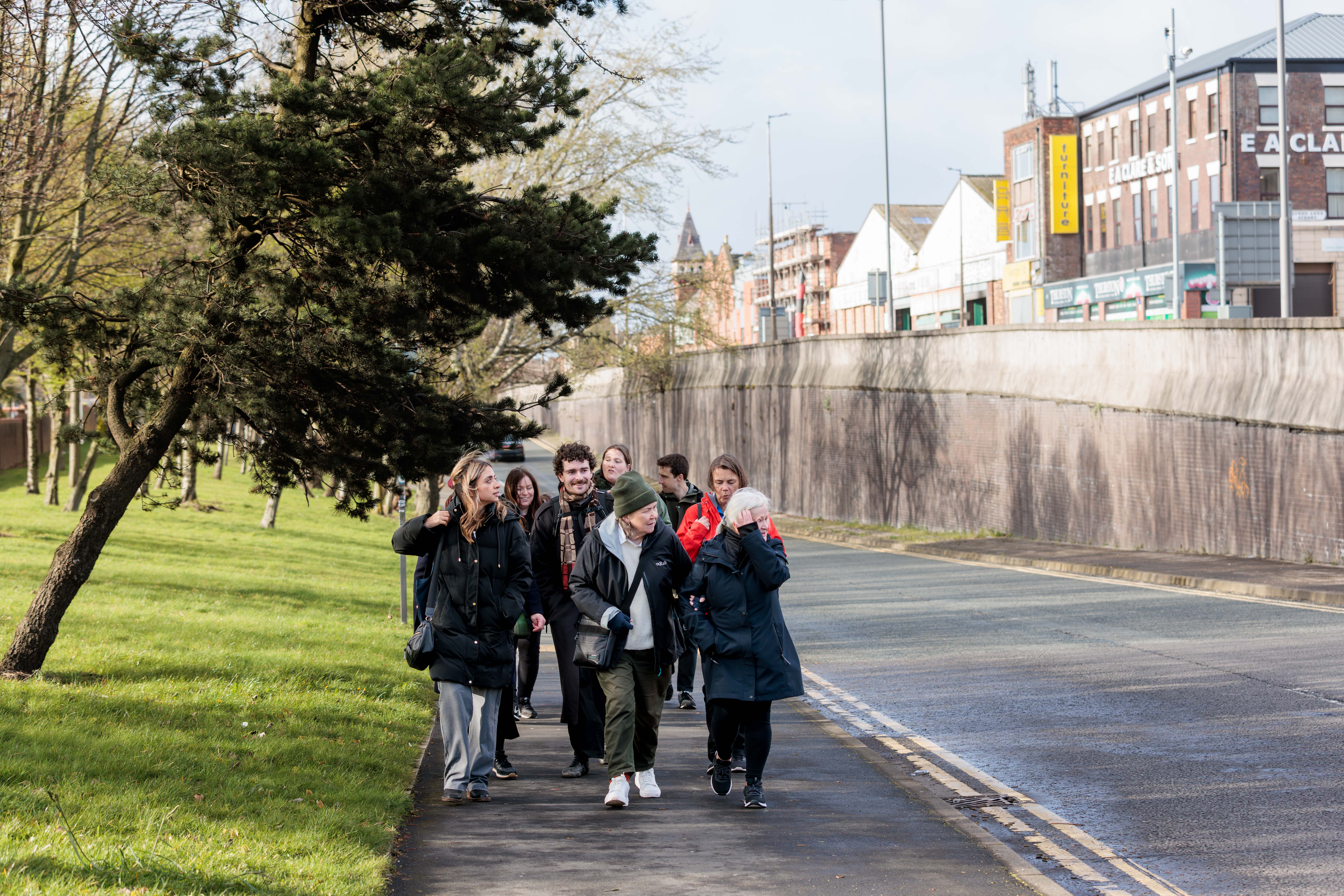 A people of people walk through Liverpool