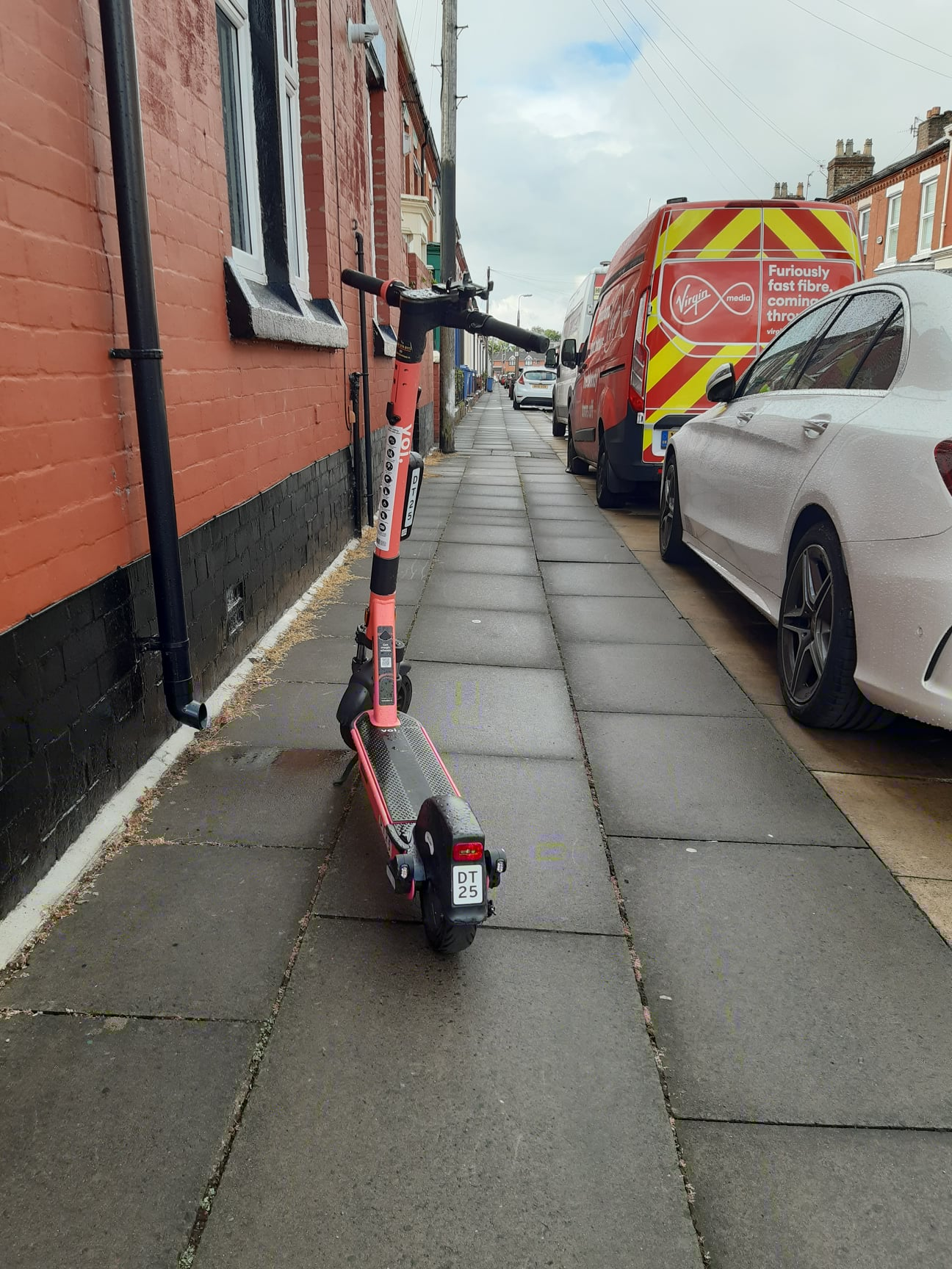 An e-scooter abandoned on the pavement