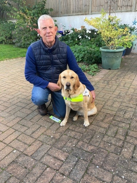 Simon knelt next to his guide dog