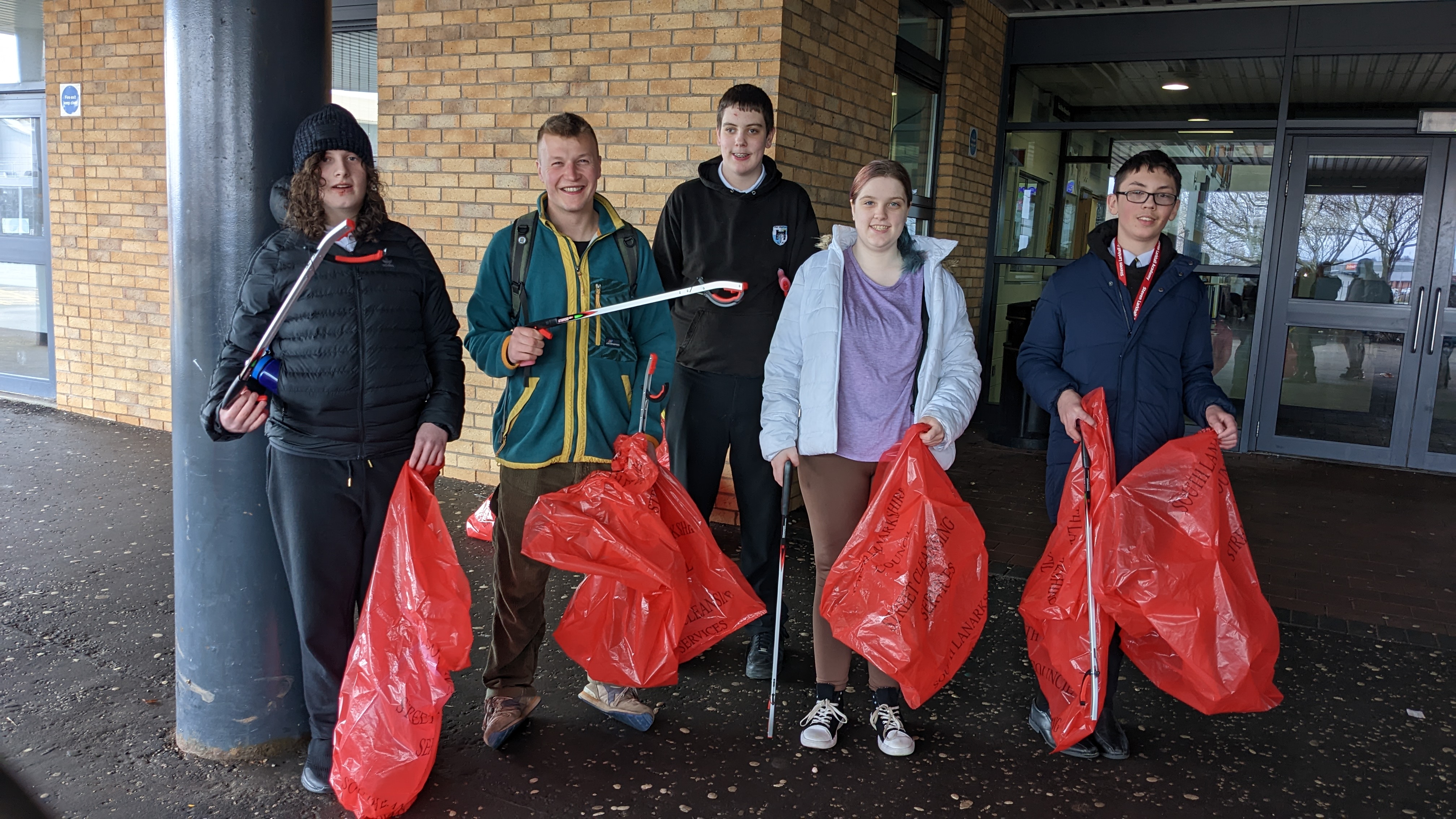 A group of people with litter pickers