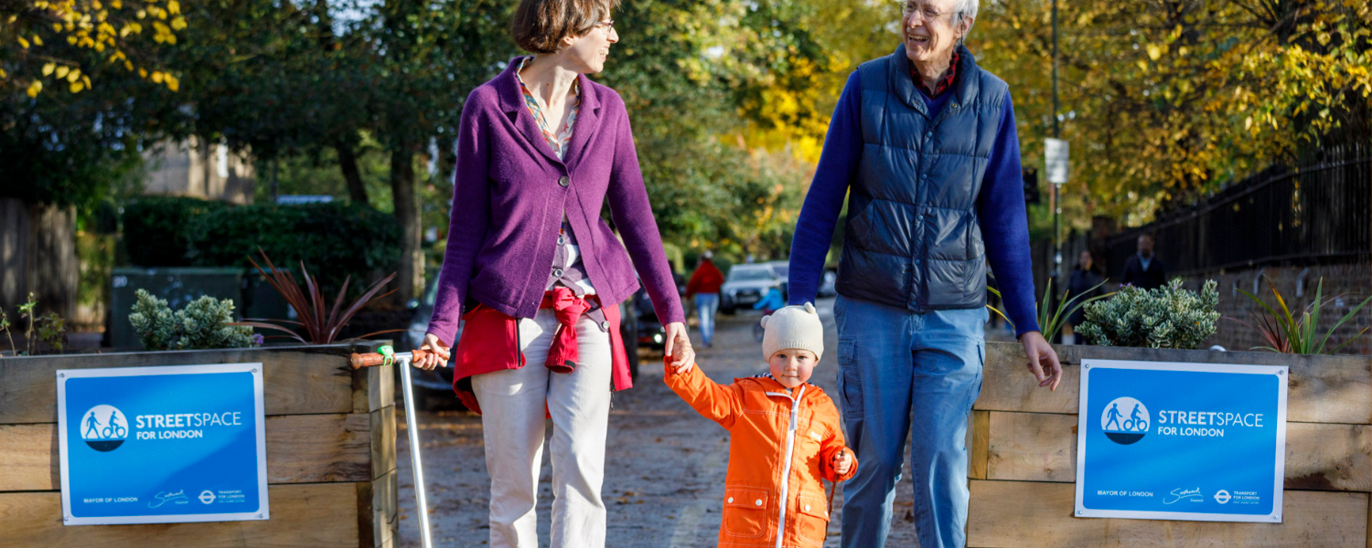 a couple and a child walk through an LTN zone