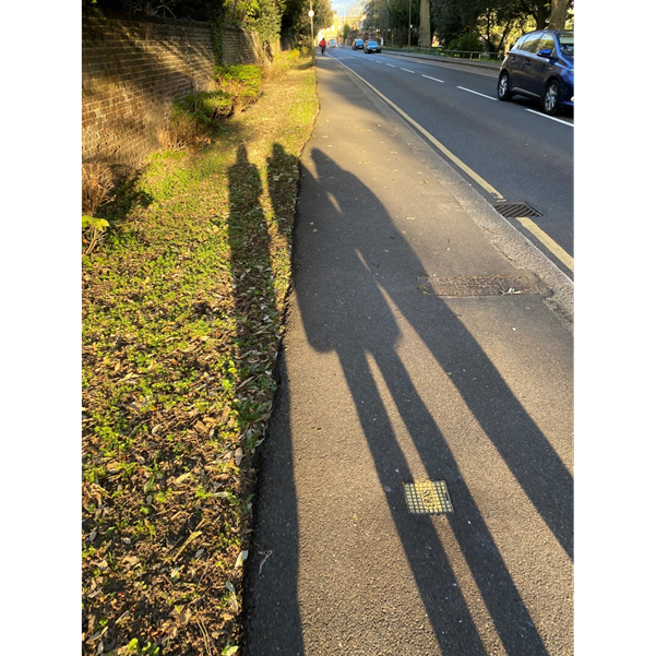 the shadow of three women on the pavement