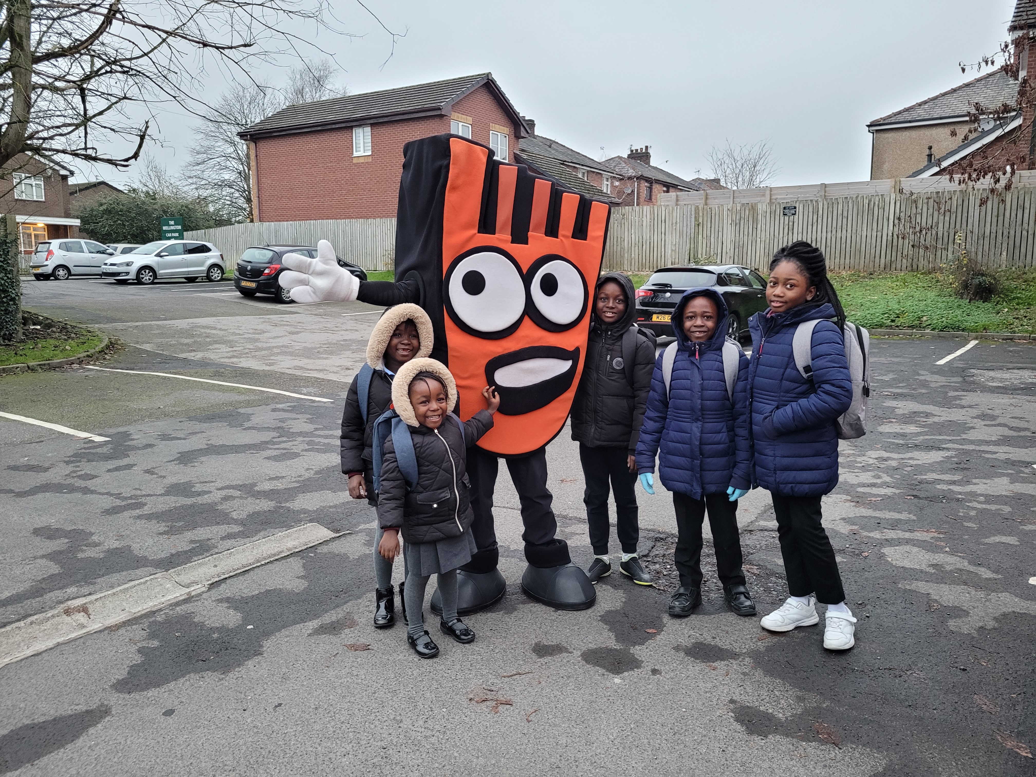 A group of pupils with Strider, Living Streets' walk to school mascot