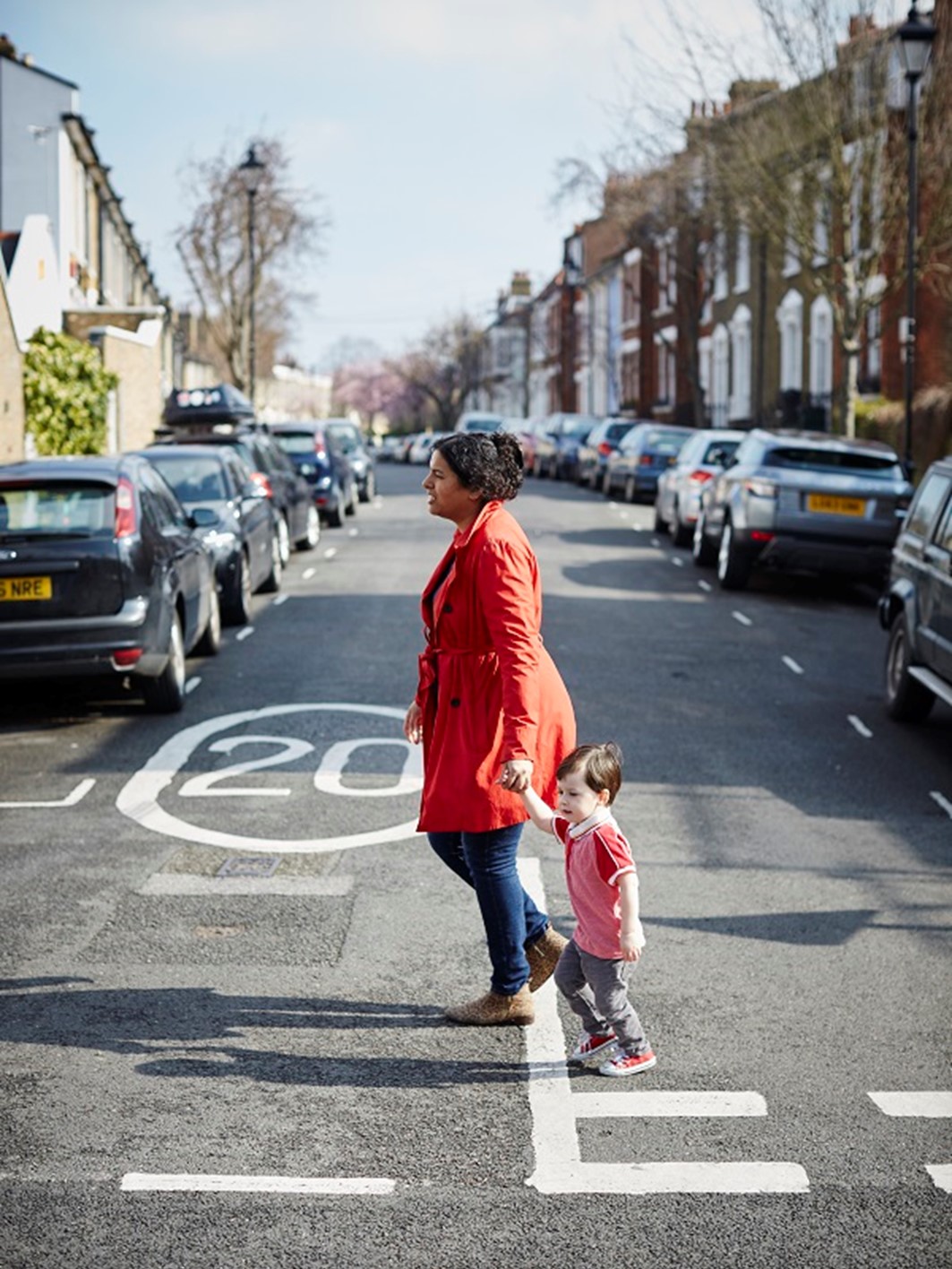 A woman and a little boy crossing the road in 20mph area