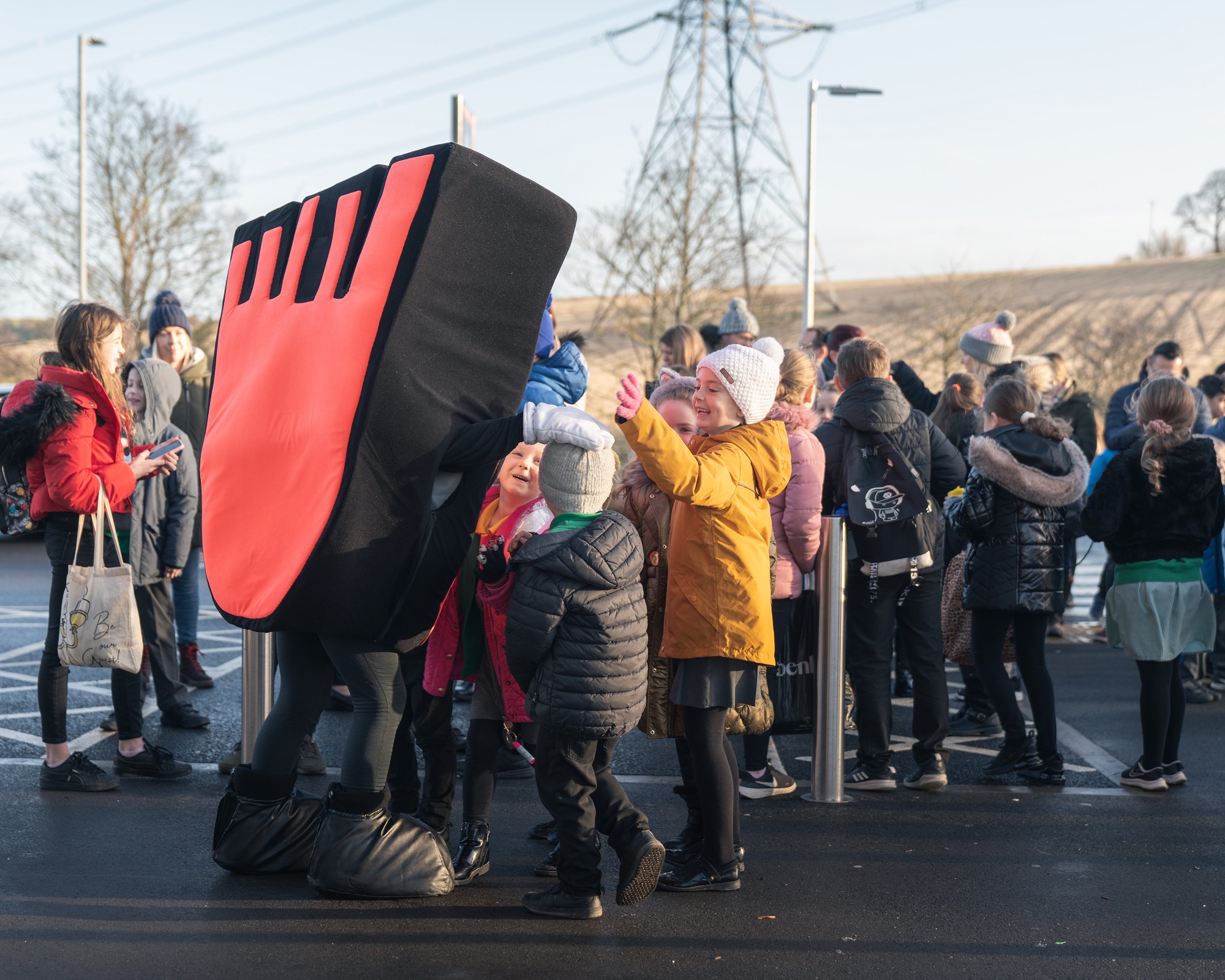 A group of pupils and Strider, Living Streets' mascot