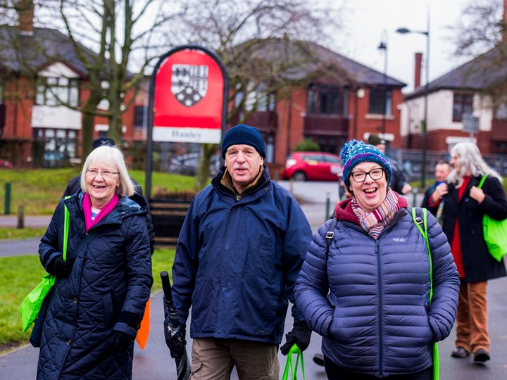 three older people walking through hanley park laughing