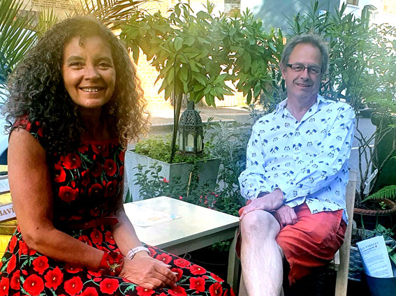 Jon and Diana sitting in their parklet smiling