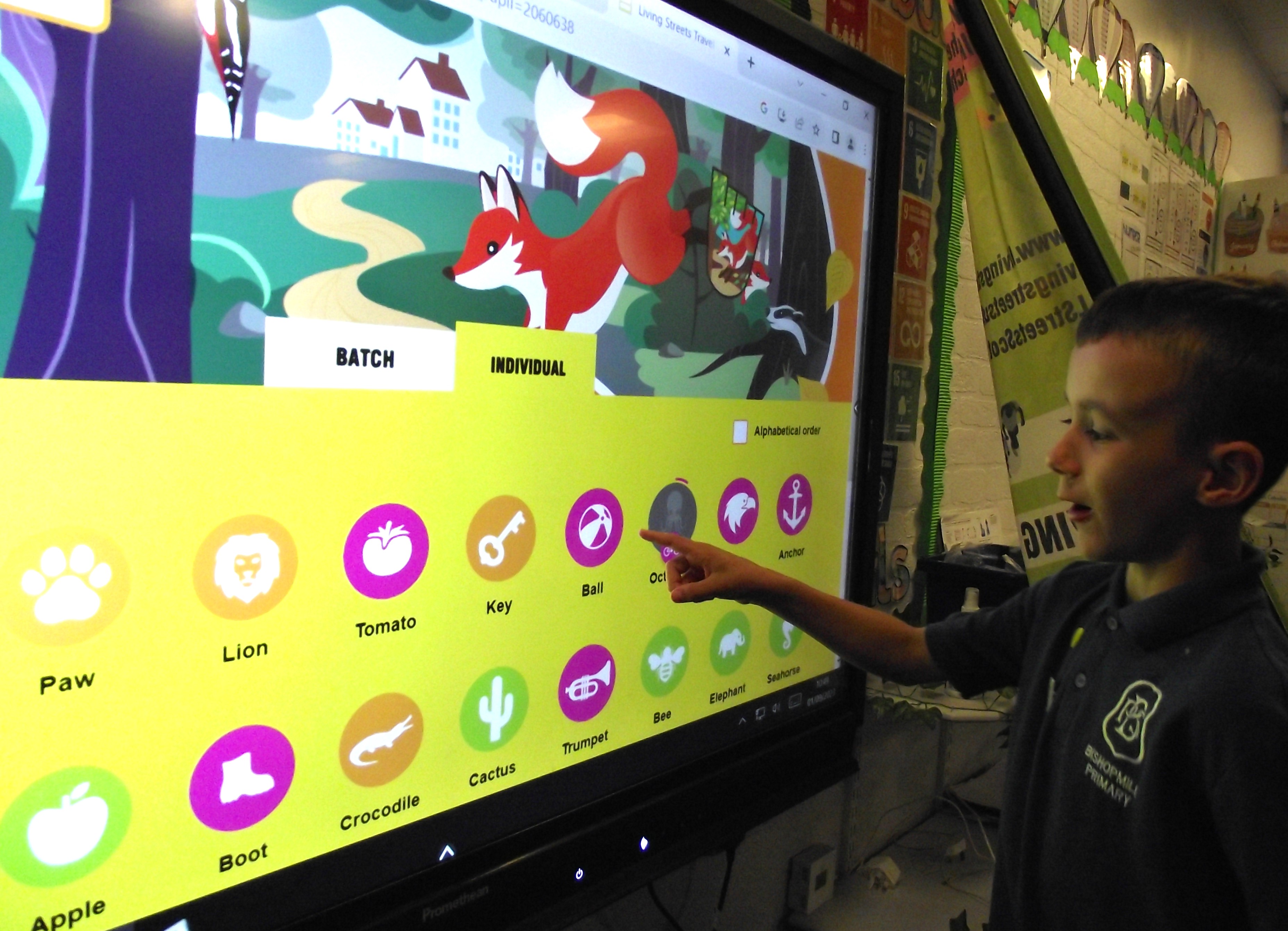 A pupil from Bishopmill Primary School uses the interactive WOW Travel Tracker to log an active journey