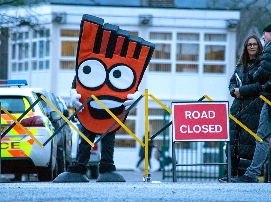 Strider with a Road Closed sign