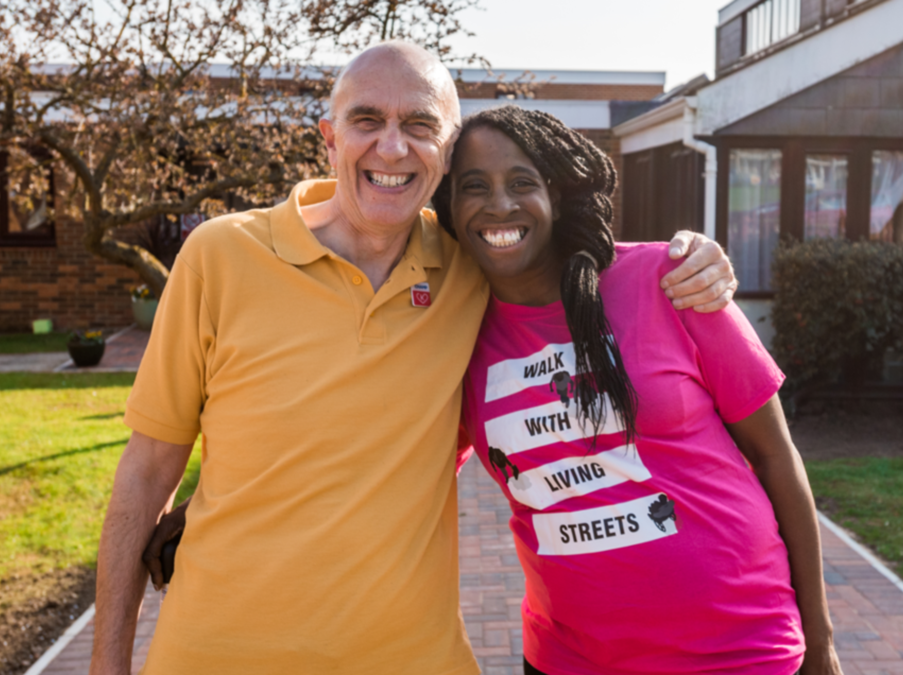 An image of two people smiling into the camera