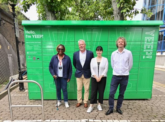 Four people are stood in front of a YEEP locker, which is situated in a car park