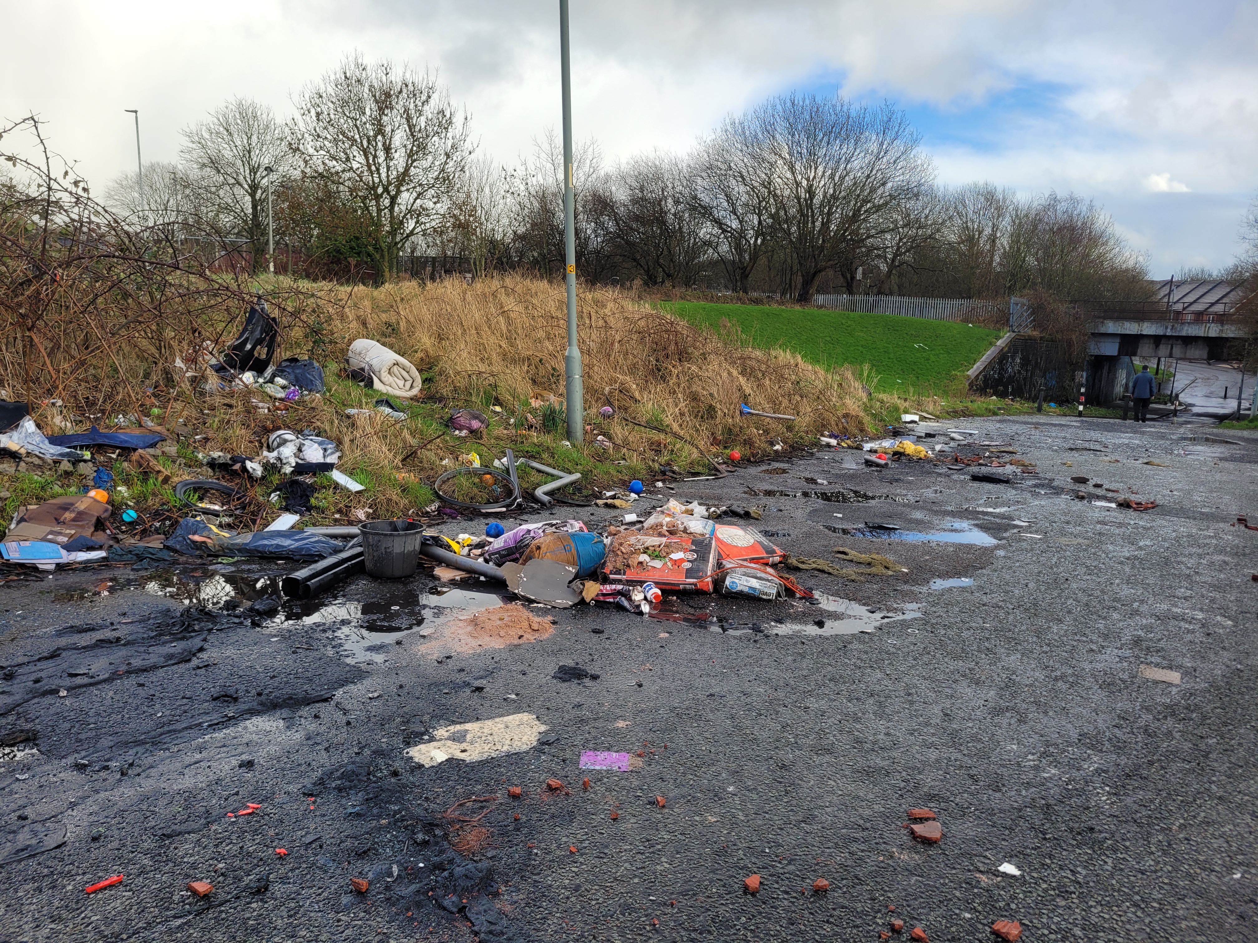 an image of wasteland with fly tipping and litter