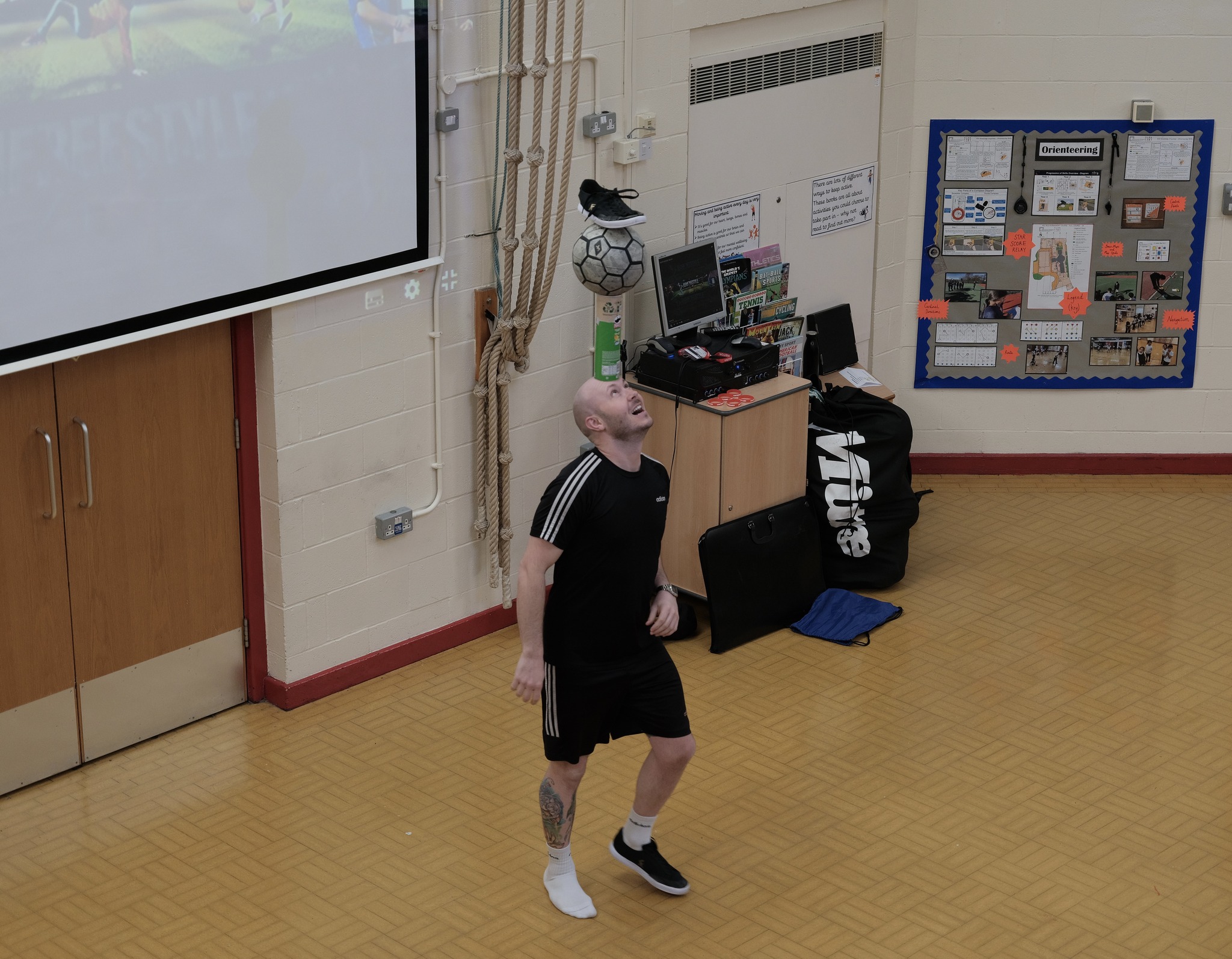 Ash Randall, freestyle footballer, shows off his moves to Stoneyholme pupils.
