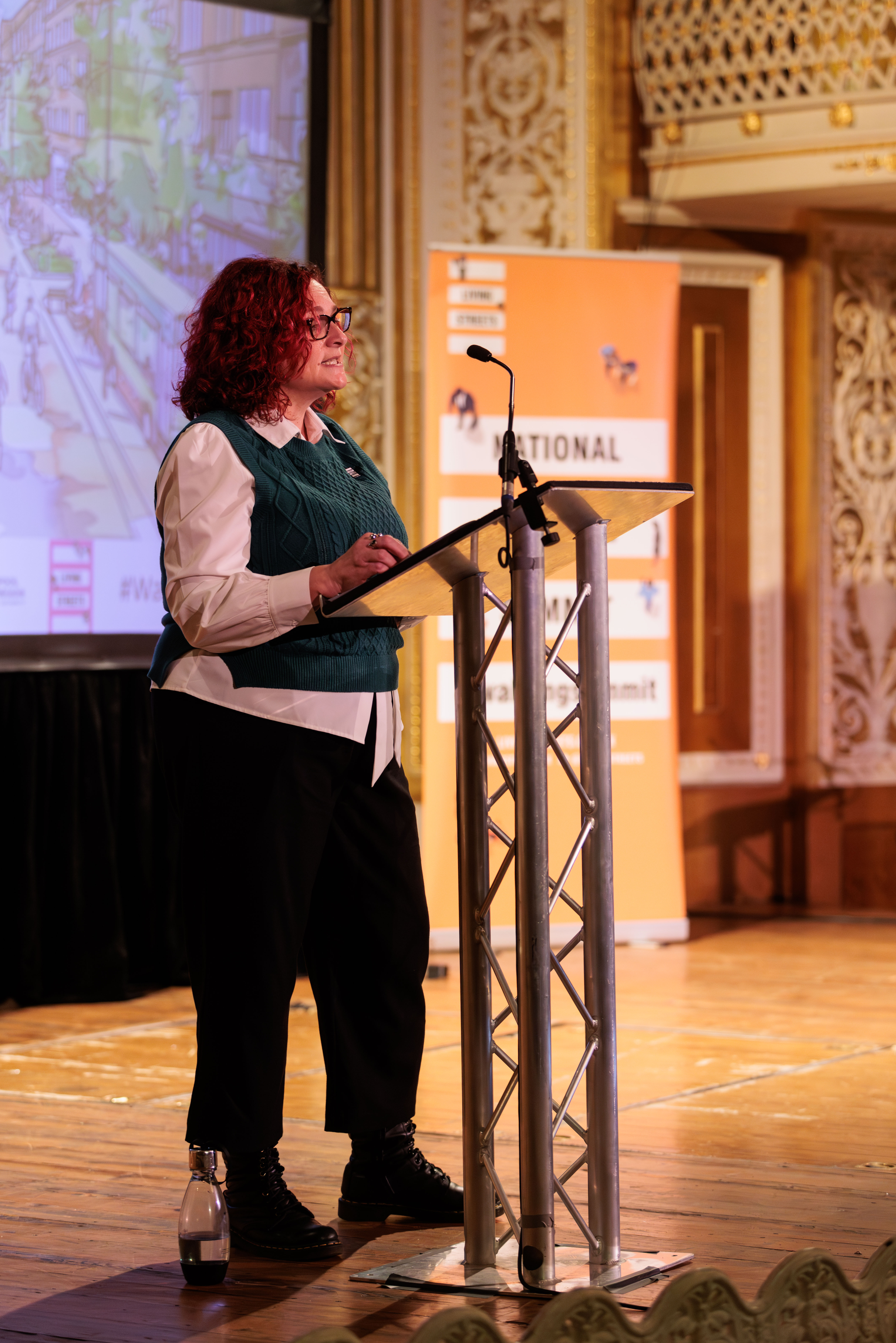 Catherine Woodhead onstage giving her opening statement at the summit