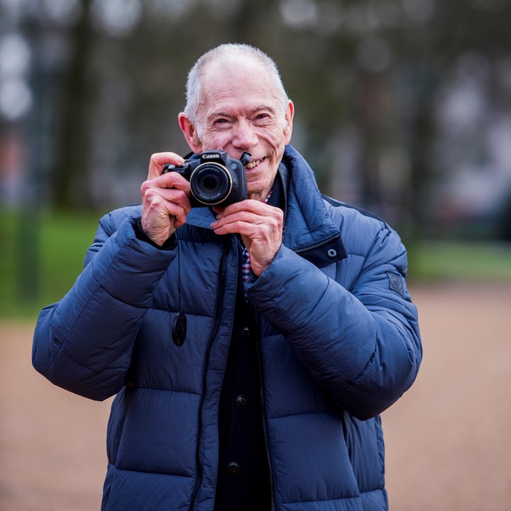 maurice holding camera and smiling