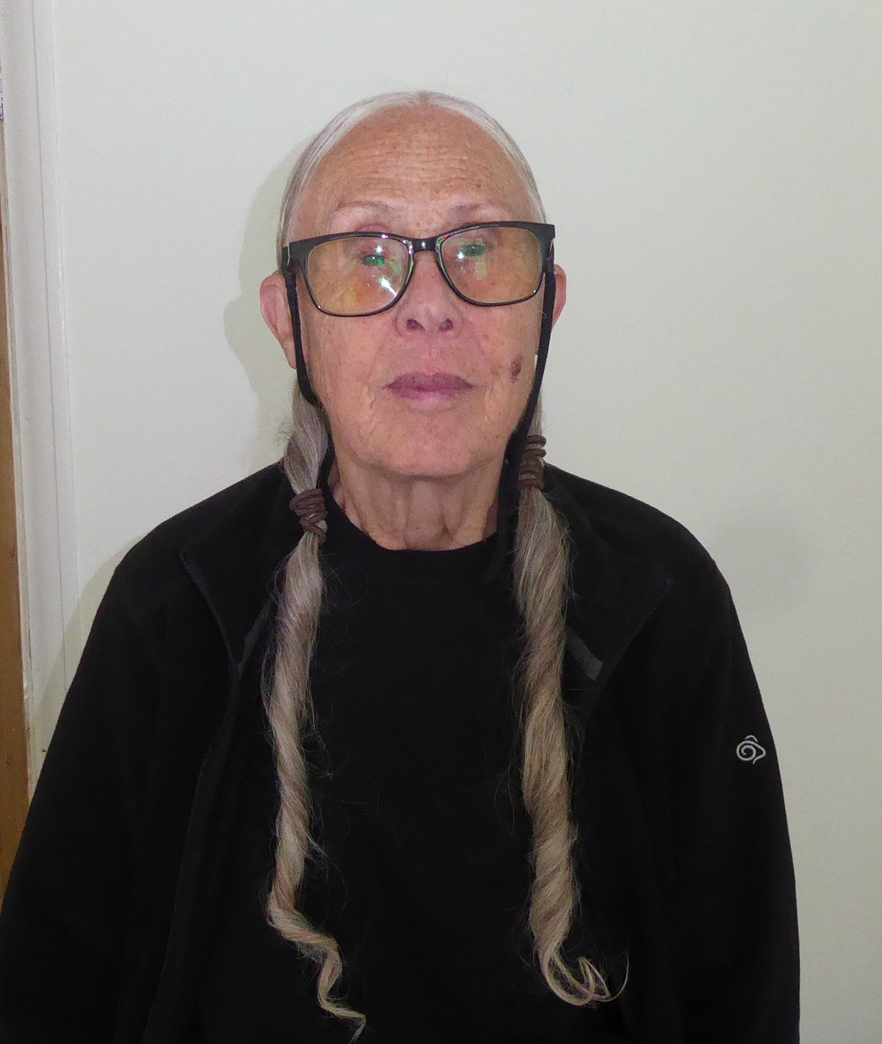Rowan, standing in front of a white wall