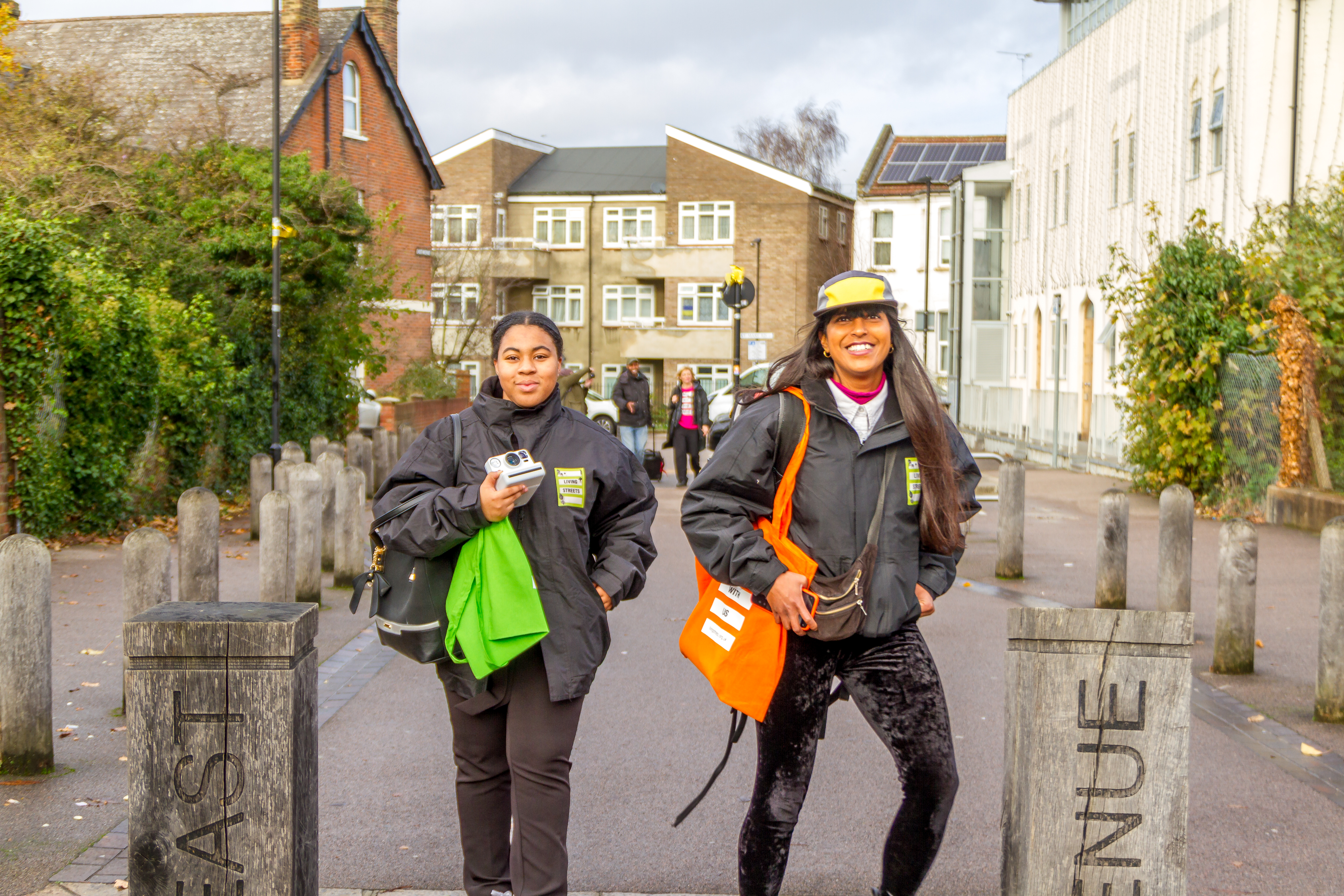 Two people pose for a photo by a pedestrian byeway