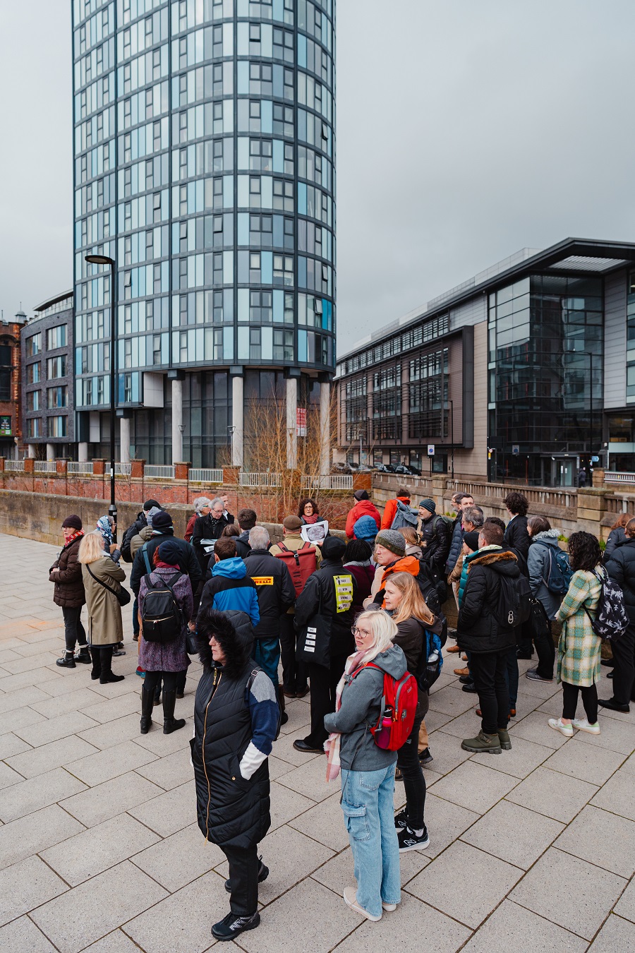 A large group of people are gathered together on a walk around Sheffield