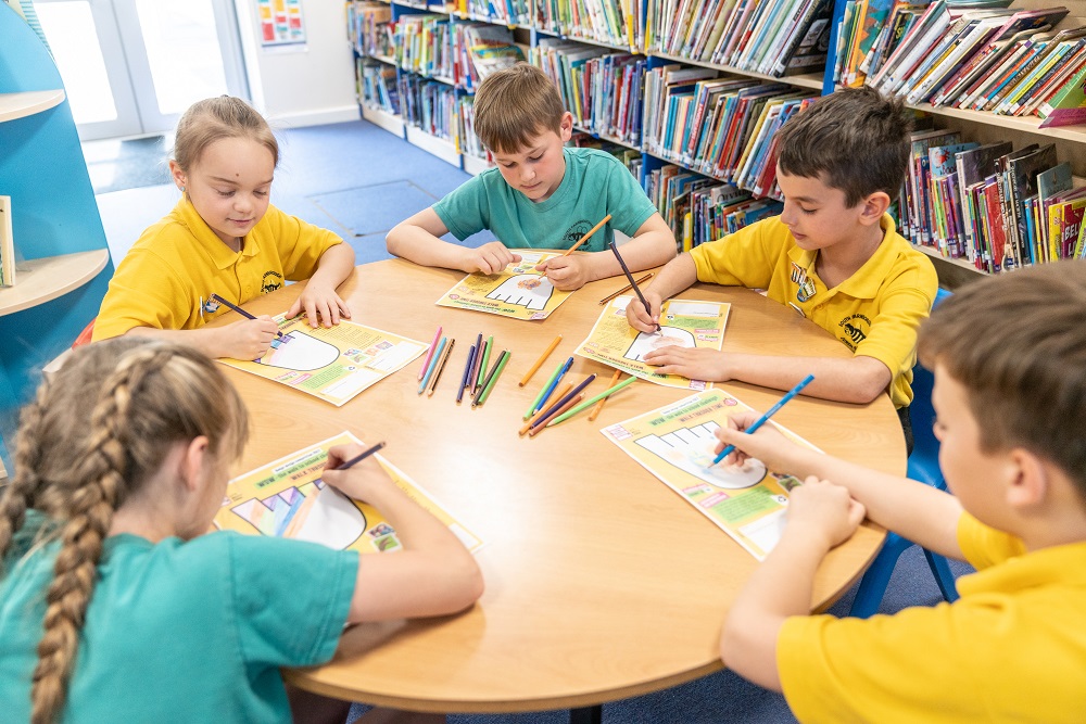 a group of children drawing badges