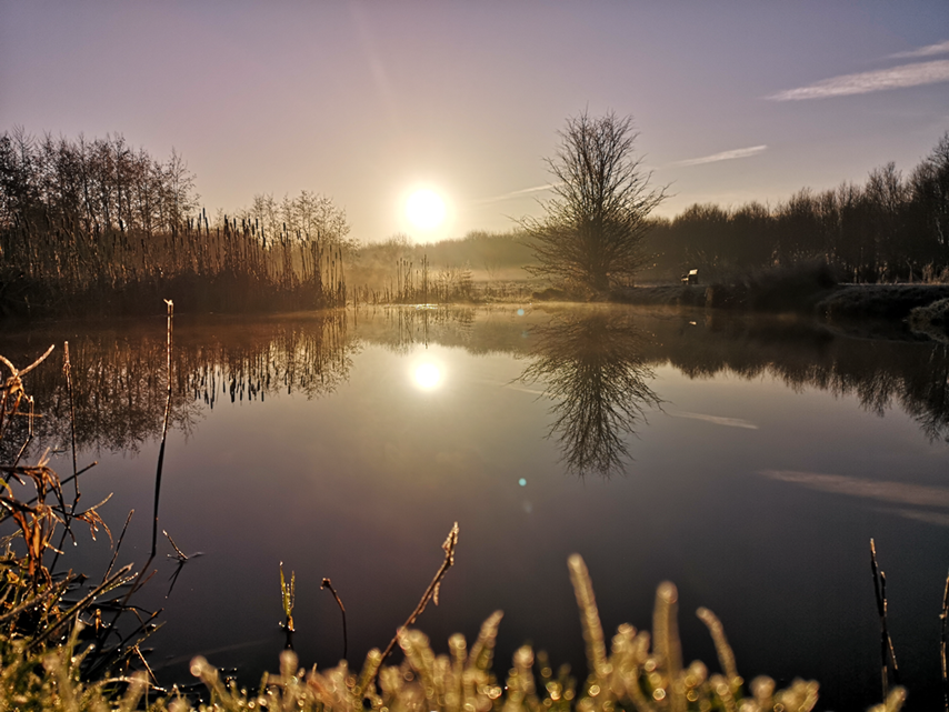 A photo of a sunrise over a body of water