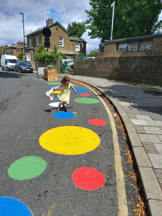 child plays on street