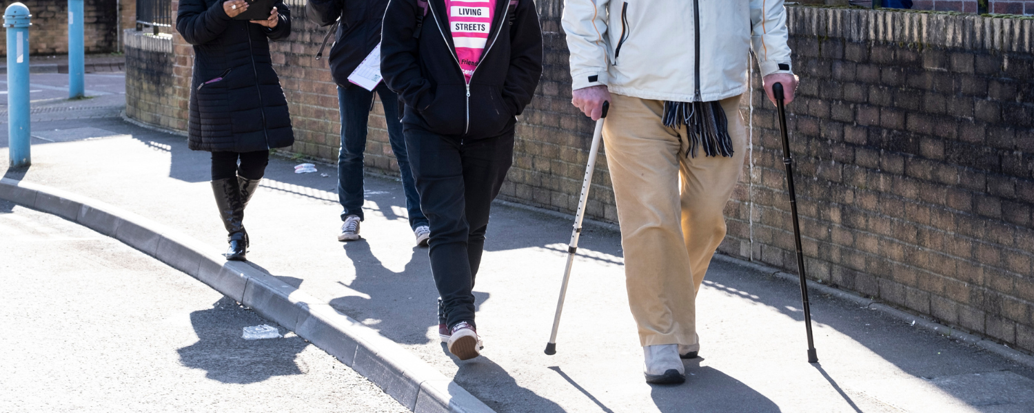 a man walking with two sticks