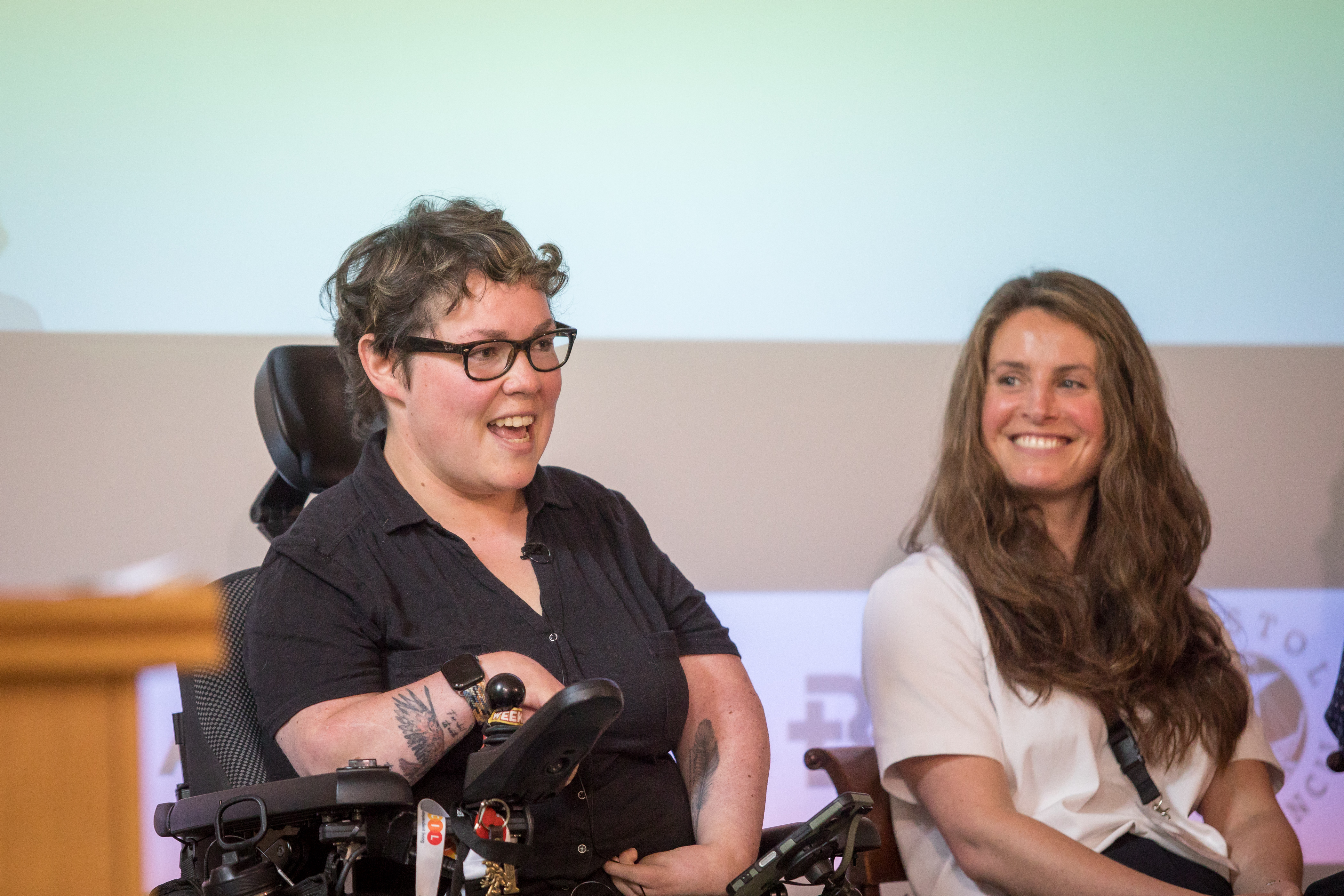 Kyrby Brown and Sophie Edmondson pictured speaking on the morning panel. Kyrby is speaking with Sophie looking and smiling at her.