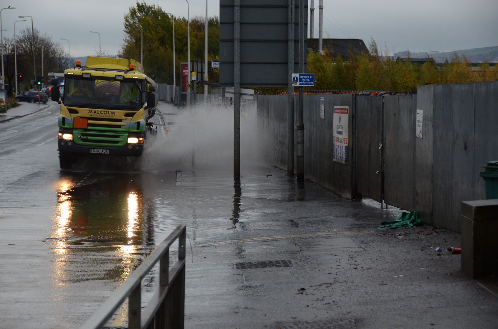 a lorry splashed the pavement driving through a puddle