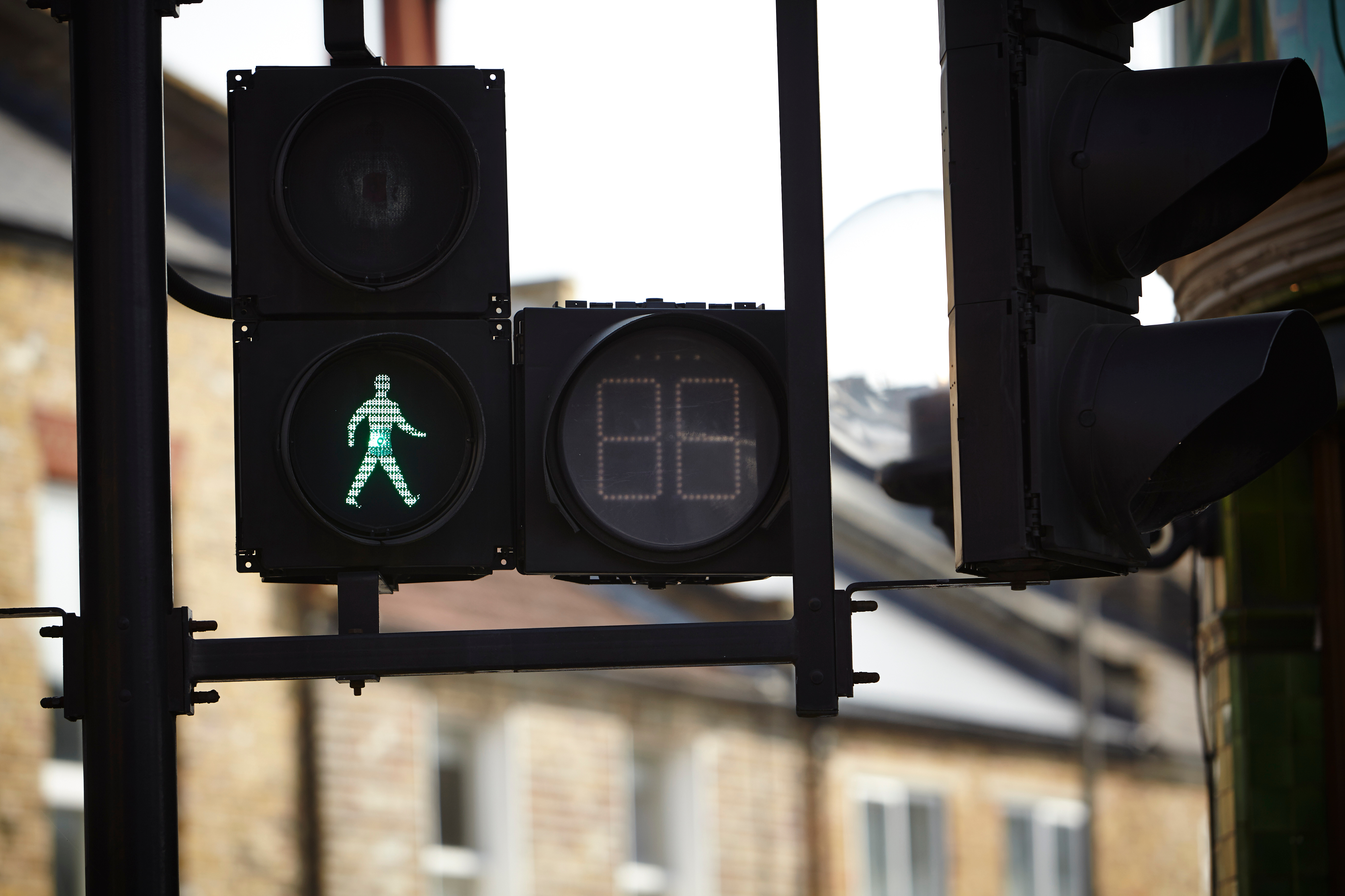 A pedestrian crossing shows a illuminated 'green man'