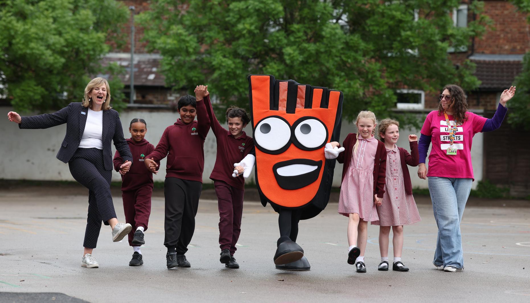 Lilian Greenwood and pupils with Living Streets' mascot, Strider